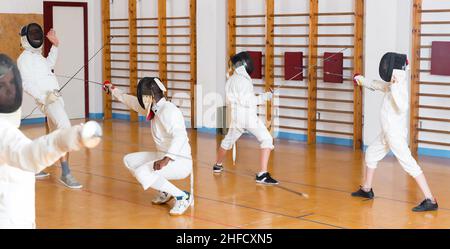 athletes practicing rapier blows in pairs Stock Photo