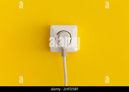 White plastic power socket on a yellow background Stock Photo