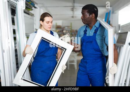 Two masters are conflicting in time working with window frame Stock Photo