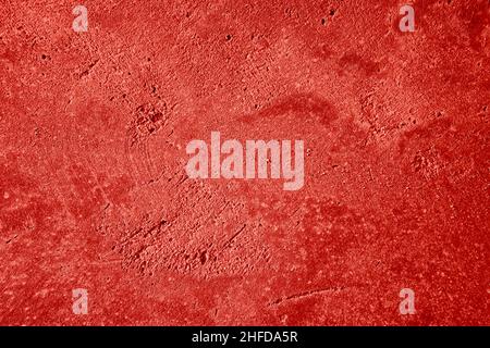 Abstract red background. Detailed plastering texture wall colored in red. Painted wall. Stock Photo