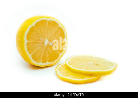 Sliced yellow lemon isolated on a white background. Fresh juicy lemon. Stock Photo