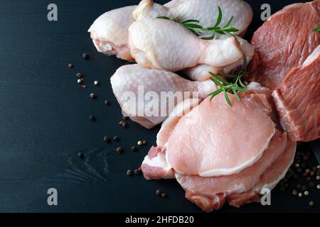 Different types of raw meat on a black backgroun Stock Photo