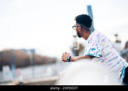 Black man with sunglasses thinking and observing the horizon Stock Photo