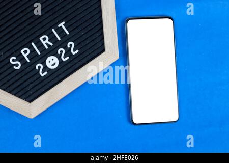2022 mobile phone and quotes on light blue background Stock Photo