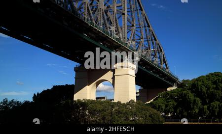 Underneath view of the iconinc Story Bridge against blue sky in Kangaroo Point Brisbane Australia seen from the City Cat ferry. Stock Photo