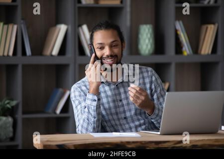 Happy busy business startup leader guy talking on mobile phone Stock Photo