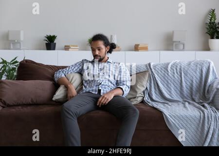 Passive bored sad African guy feeling tired, suffering from apathy Stock Photo