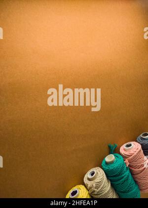 colorful reels of macrame cord threads or wool shot as copy space background or text background. studio shot. Stock Photo