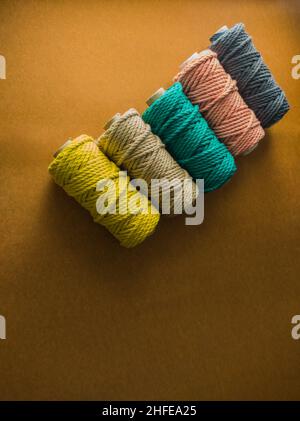 colorful reels of macrame cord threads or wool shot as copy space background or text background. studio shot. Stock Photo