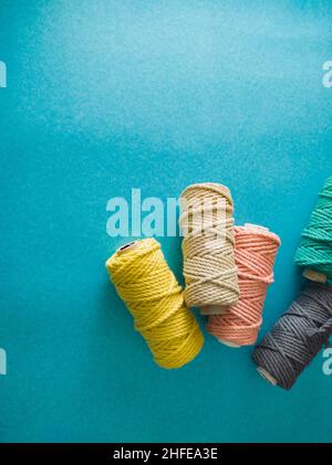 colorful reels of macrame cord threads or wool shot as copy space background or text background. studio shot. Stock Photo