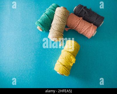 colorful reels of macrame cord threads or wool shot as copy space background or text background. studio shot. Stock Photo