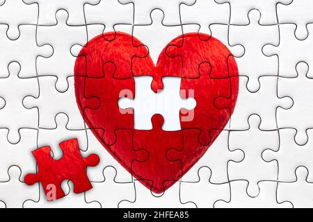 last piece to complete heart jigsaw puzzles for full fill love together concept Stock Photo