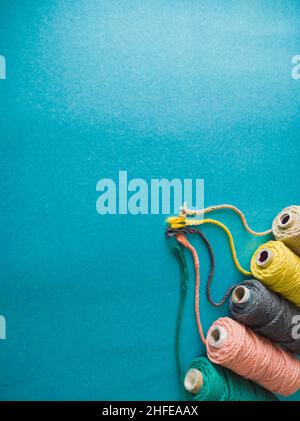 colorful reels of macrame cord threads or wool shot as copy space background or text background. studio shot. Stock Photo