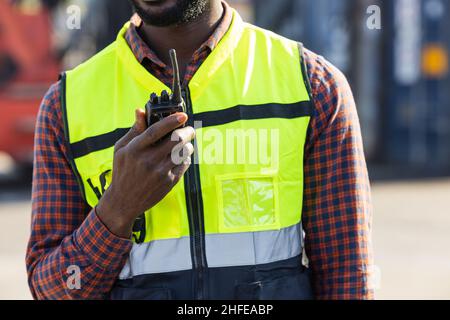 closeup worker using ham radio for operation control in cargo port shipping Stock Photo