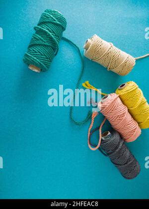 colorful reels of macrame cord threads or wool shot as copy space background or text background. studio shot. Stock Photo