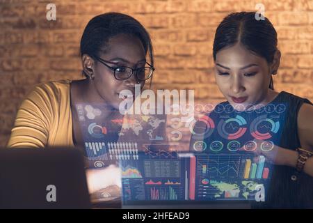 businesswomen using advance technology hologram computer display business information data Stock Photo