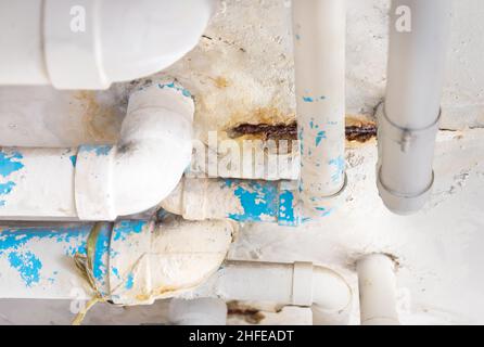 Damaged PVC Water pipe leak , building drainage pipes crack seep problem need to fix Stock Photo