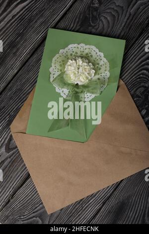 Greeting card in an envelope. On pine boards. Stock Photo
