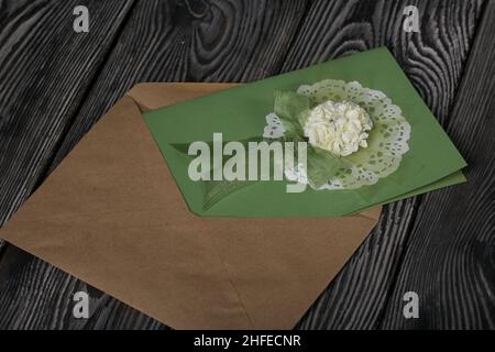 Greeting card in an envelope. On pine boards. Stock Photo