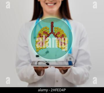 Lungs treatment concept. doctor holding holographic healthy human lungs while standing at medical clinic Stock Photo