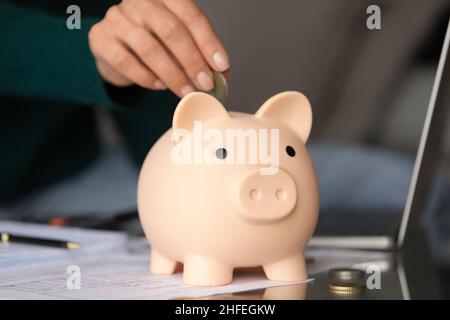 Close up young woman saving money for future. Stock Photo