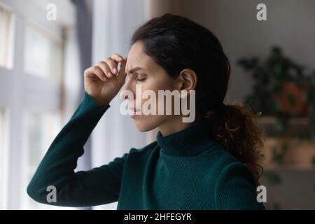 Stressed young hispanic woman suffering from depression. Stock Photo