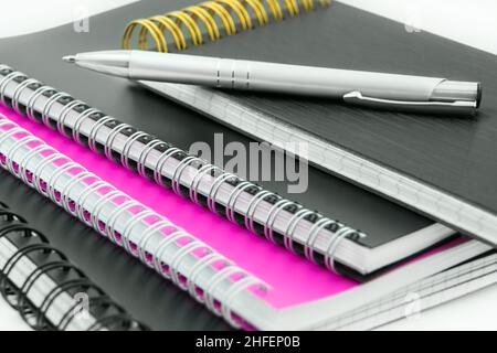 Various paper products with spiral binding and pencil close up Stock Photo