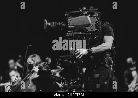 Bucharest, Romania - January 15, 2022: Professional steadicam (gimbal) operator filming a classical music concert. Stock Photo