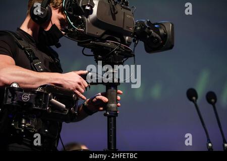 Bucharest, Romania - January 15, 2022: Professional steadicam (gimbal) operator filming a classical music concert. Stock Photo