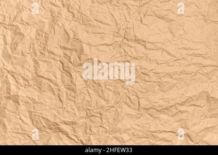 Crumpled brown kraft paper background. Abstract texture for design. Copy space for ad or announcement. Top view Stock Photo