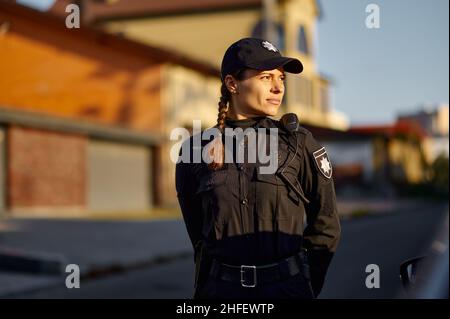 Woman police officer in uniform outdoors portrait Stock Photo