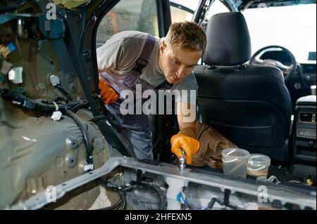 Automotive worker engaged in car body work Stock Photo - Alamy