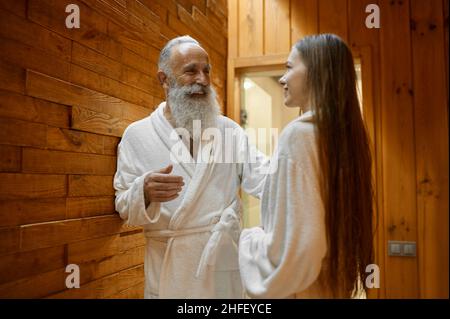 Man and woman talking in spa sauna Stock Photo