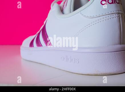 Badajoz, Spain, adidas pink sneakers shoes with shoelace side view on floor soft focus with copy space Stock Photo - Alamy