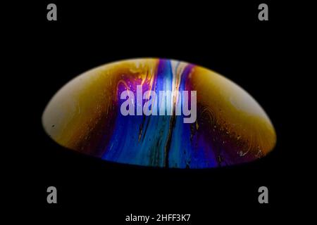 Vibrant colored multicolor psychedelic alien planet in the darkness of the universe, soap bobble close-up Stock Photo