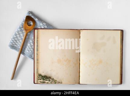 open recipe book and wooden spoon, food,,cooking and kitchen concept,free copy space on the empty  pages Stock Photo