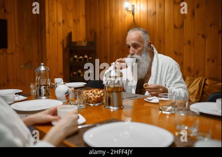 Senior man rest with friends in sauna Stock Photo