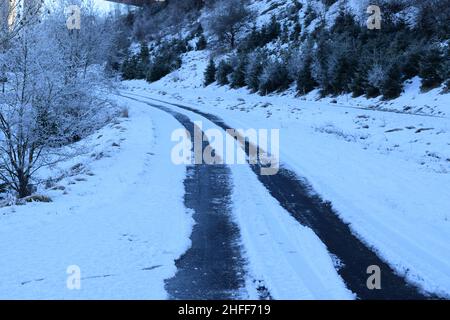 tire tracks in snow on a rural road Stock Photo