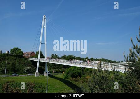 Exeter, UK - May 2018: The Baker Bridge is a cable stayed footbridge built in 2007, with an A-frame steel tower that crosses the A379 carriageway at 1 Stock Photo
