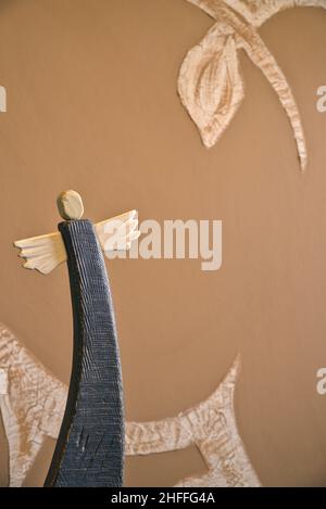 wooden painted angel on abstract blurry background, beautiful angel in folk minimal style Stock Photo