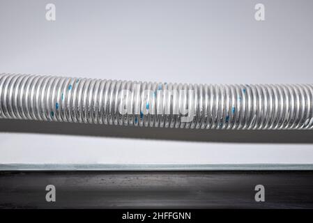 Torsion spring tensioning the garage door mechanism painted blue, the gate seal is visible. Stock Photo