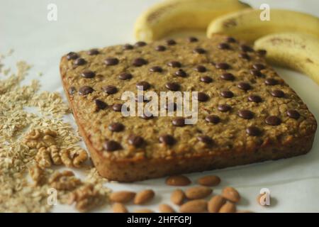 Oats banana breakfast bar. A quick and healthy snack with rolled oats, whole wheat flour, bananas, nuts and choco chips as main ingredients. Shot with Stock Photo