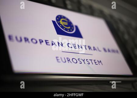 Viersen, Germany - January 9. 2022: Closeup of mobile phone with logo lettering of european central bank on computer keyboard Stock Photo