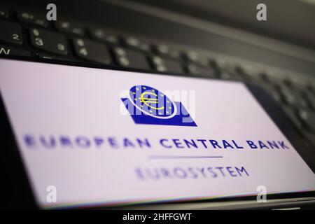 Viersen, Germany - January 9. 2022: Closeup of mobile phone with logo lettering of european central bank on computer keyboard Stock Photo