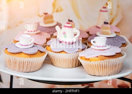 Cakes from dough and sponge cake with cups and teapot figurines, sweetly Stock Photo
