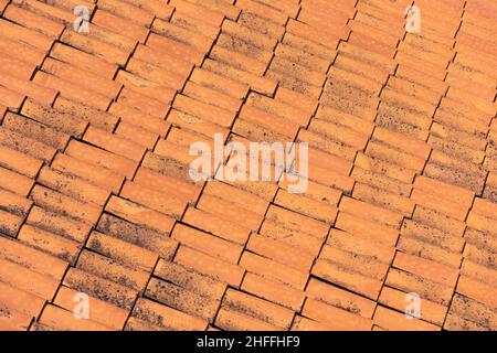 Ceramic orange clay tiles on the roof of a building Stock Photo