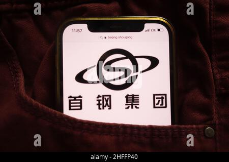 KONSKIE, POLAND - January 15, 2022: Beijing Shougang Co Ltd logo displayed on mobile phone hidden in jeans pocket Stock Photo