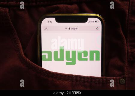 KONSKIE, POLAND - January 15, 2022: Adyen NV logo displayed on mobile phone hidden in jeans pocket Stock Photo
