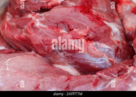 Defocus texture or background of tasty fresh meat of big, pork. Red beef meat close up texture. Meat food background. Blurred. Fresh meat. Out of Stock Photo