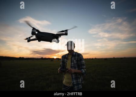Farmer with drone on a field. Smart farming and precision agriculture Stock Photo